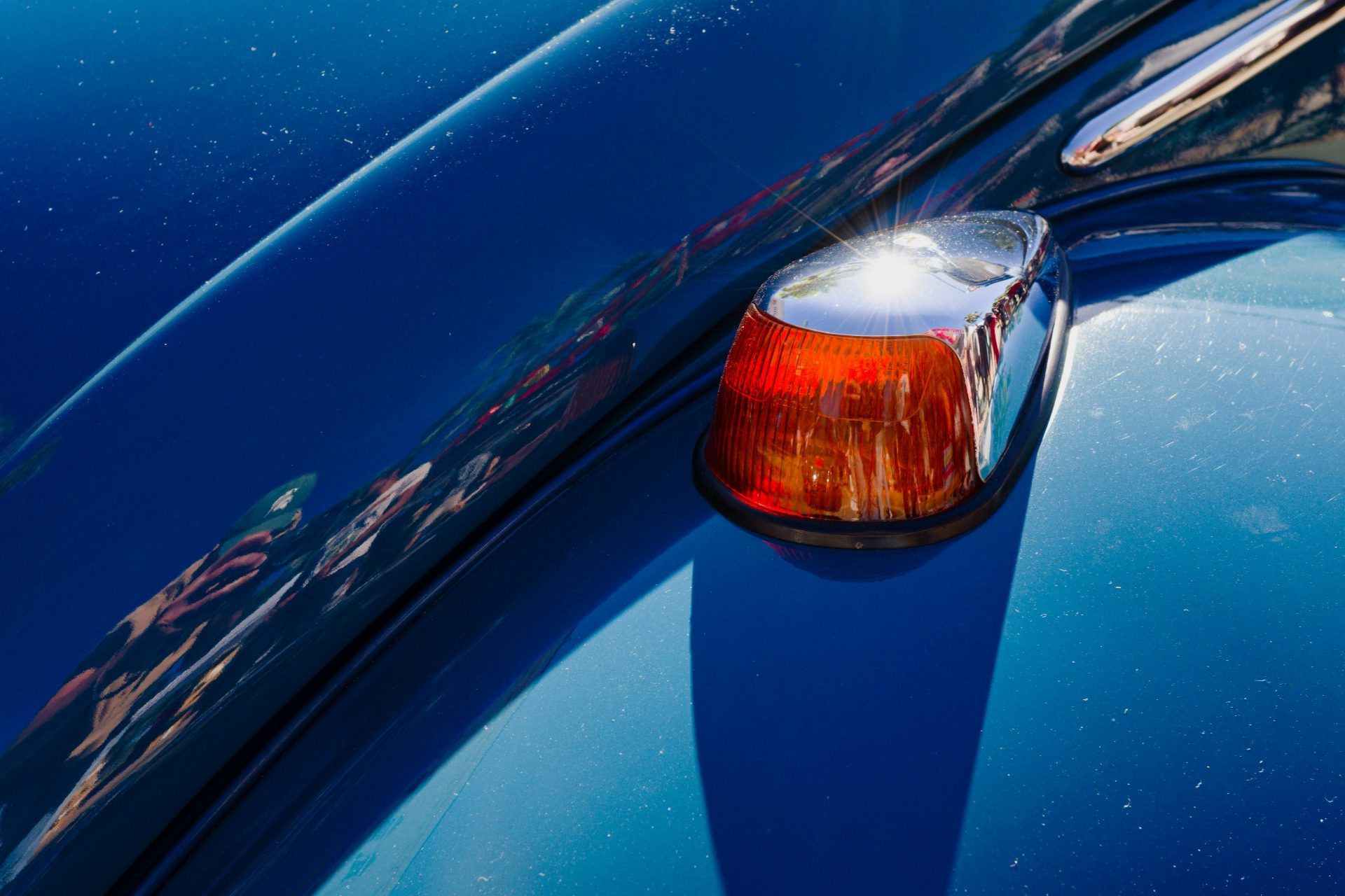 a close up of the tail light of a blue car